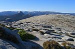 The summit is large and relatively flat, with some unique rock formations.