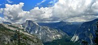 The view east and south from the cliffs above Yosemite Point. From left to right, in the distance far left is Cloud's Rest, North Dome in front of Halfdome, then Mt. Starr-King poking into the clouds and Glacier Point at right.
