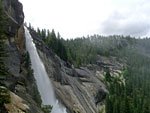 Nevada Falls drops off a wide, high cliff. The John Muir Trail follows this cliff and drops down the far side of the river