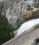Hikers make their way up the final steep stairs to the top