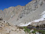 The stream sometimes hides under boulders and snow, sometime flows out in the open