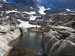 Campers look for flat spots on and below Trail Camp boulders