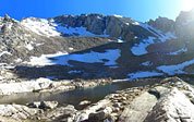 A hiker on a boulder (center left) checks out the view. Most Trail Camp'ers set up near this lake-like strip of water. 