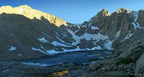 Last light on Consultation Lake. You can see a light blue tent nestled in the rocks left of the sunlight reflection at bottom center 