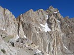 A marmot poses below the pointy peak of Mt. Muir