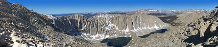 A hiker (far left) makes his way up through the rubble field that is the western side of Mt. Whitney  
