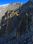 The trail (top right) climbs out of the jagged spires onto a boulder slope for the last 1.5 miles to the Whitney summit (top)