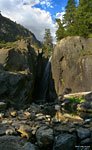 At the western base of the Muir Gorge bypass by a bridge, this waterfall from a tributary stream 