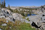 The winding path threads through an obstacle course of ponds and craggy mounds