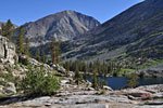 A hiker (center) by Dollar Lake below Baxter Pass 