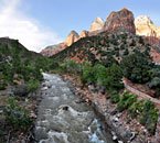 Colors of dusk transform the river  from its customary reddish brown hue.
