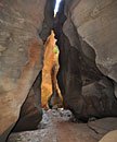 Rarely in direct sunlight, the cool canyon sometimes opens up to glimpses of the hot landscape above.