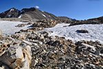 The final miles to the top pass through rubble fields and snow drifts.