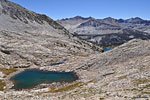 Near the top of Cartridge Pass, a tarn in the foreground, a bit of the unnamed lake and far across the valley, Bench Lake.