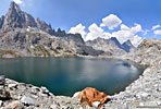 A lone red rock at Cecile Lake